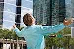 Rear view of a businessman standing with his arms outstretched