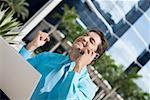 Businessman talking on a mobile phone and looking excited