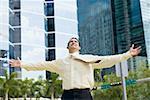 Businessman standing with his arms outstretched