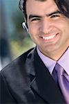 Portrait of a businessman wearing a hands free device and smiling