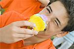 Portrait of a boy eating a cupcake