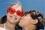 Low angle view of a boy kissing a girl