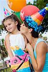 Side profile of a mid adult woman kissing her daughter