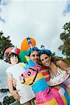 Portrait of a mid adult couple celebrating birthday with their daughter