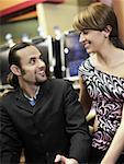 Mid adult man and a young woman looking at each other in a casino