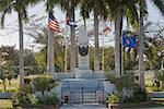 Statue surrounded by flags in a park, Bayview Park, Key West, Florida, USA