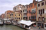 Group of people walking on a promenade along a canal, Venice, Italy