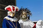 Close-up of two people wearing masquerade masks, Venice, Italy