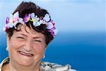 Portrait of a mature woman wearing a wreath and smiling, Diamond Head, Waikiki Beach, Honolulu, Oahu, Hawaii Islands,