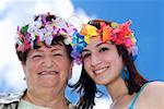 Portrait of a senior woman and her daughter wearing flowers