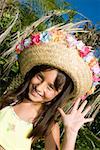 Portrait of a girl wearing a straw hat and dancing