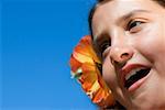 Close-up of a girl wearing flowers and shouting