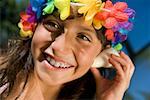 Close-up of a girl listening to a conch shell and smiling