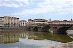 Reflection of an arch bridge in water, Ponte Santa Trinita Bridge Arno River, Florence, Italy