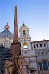 Low angle view of an obelisk in front of a church, Fountain of the Four Rivers, Piazza Navona, Rome, Italy