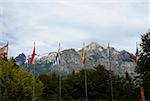 Flags and trees in front of mountains, San Carlos De Bariloche, Argentina