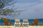 Four deck chairs on the beach, Dixon Cove, Roatan, Bay Islands, Honduras