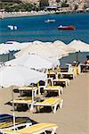 Lounge chairs and beach umbrellas on the beach, Lindos, Rhodes, Dodecanese Islands, Greece