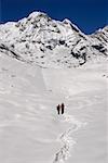 Two hikers standing in a snow covered landscape, Annapurna Range, Himalayas, Nepal