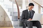 Businessman on Steps with Laptop Computer