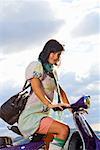 Woman on scooter.