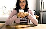 Woman holding glass of milk.