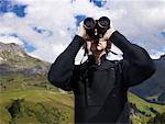 Man looking through his binoculars.