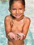 Little girl holding a frog.