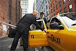 Business People Sharing Taxi Cab, New York City, New York, USA