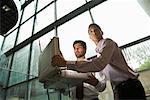 Businessmen Looking Inside Glowing Briefcase