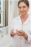 Portrait of Woman Holding Moisturizer