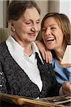 Mother and Daughter Looking at Photo Album