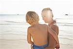 Mother Carrying Son on Beach, Majorca, Spain