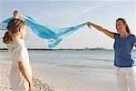 Mother and Daughter Holding Sarong in Wind, Majorca, Spain