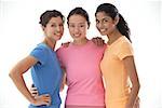 Three women of mixed race, smiling at camera, portrait