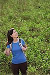 Woman hiking outdoors, nature, looking up to sky