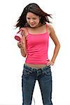 Young woman wearing pink top and blow drying hair