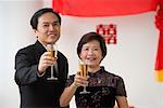 A couple raise their glasses for a toast