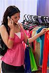 A teenage girl out shopping while she talks on her cellphone