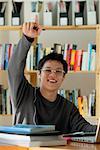 A young man studies in the library