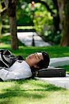 A man lies down and has a rest in the park