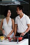 A couple prepare dinner together in the kitchen