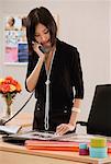 A woman talks on the phone at work