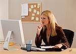 A woman works at her desk