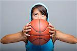 Young woman with basketball looking up