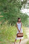 Woman with basket looking at camera