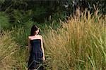 Woman walking in long grass