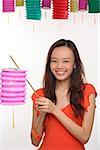 Young woman with Chinese lantern smiling at camera