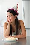 Young woman with cake smiling