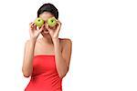 Young woman holding two apples over eyes